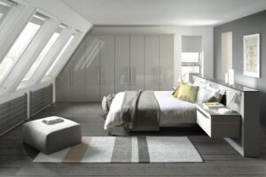 Modern bedroom with Edged Phoenix wardrobe doors in sleek gloss light grey, with integrated headboard with nightstands and lamps