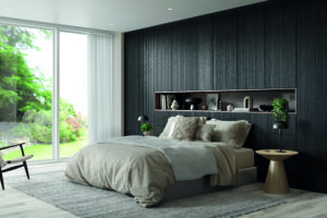 Full wall Legno black wardrobes with Ella doors and a built in shelf, set behind a large bed