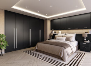 Sophisticated bedroom with Glacier super matt black wall-mounted wardrobe doors and vertical handle detailing, against a herringbone wood floor