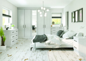 Light concrete (grey) built-in wardrobe with Monaco doors, with matching drawers in a sleek bedroom