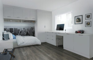 Minimalist bedroom with Scoop doors in light grey, for the wall-mounted storage above single bed and built-in desk with transparent chair