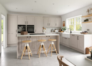 Modern kitchen with Turnbury doors in Cashmere (light beige / grey), featuring an island and breakfast bar